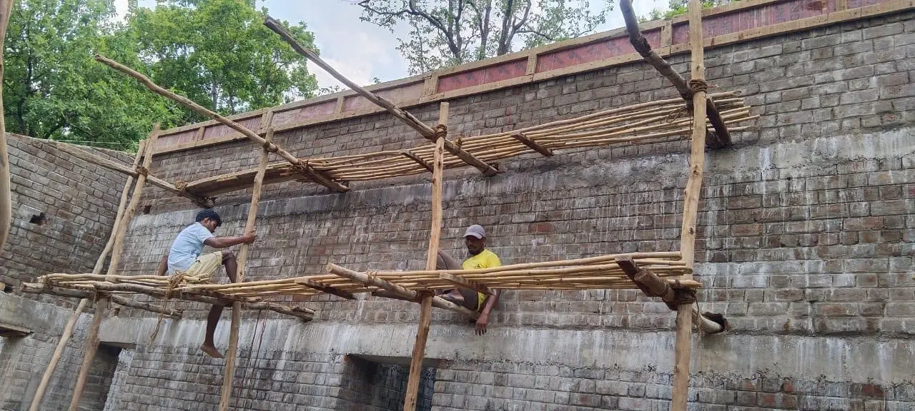 Workers on the wall-top scaffold at Forest Rest House